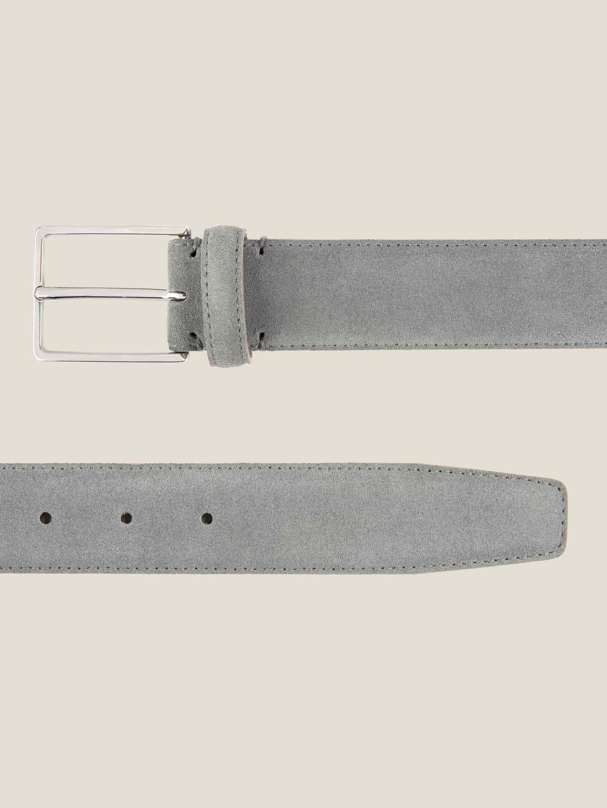 Flat lay close-up of the French Blue Classic Suede Belt, showing detail of the silver buckle and the suede strap tip.