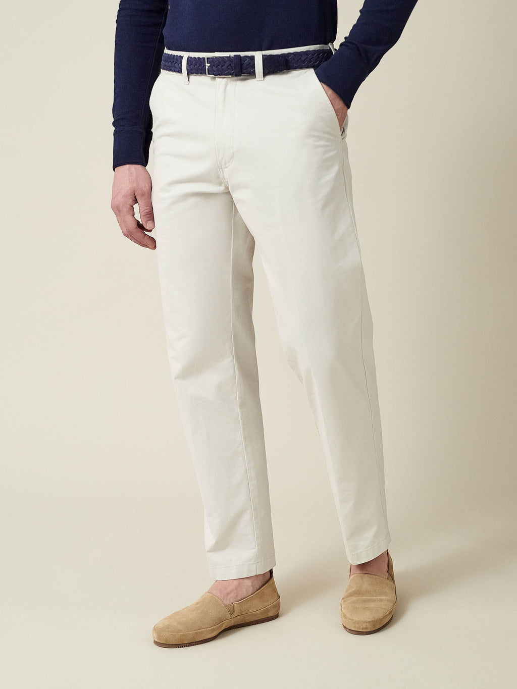Model wearing the Luca Faloni Navy Blue Woven Suede Belt, paired with off-white trousers and a navy long-sleeve top.