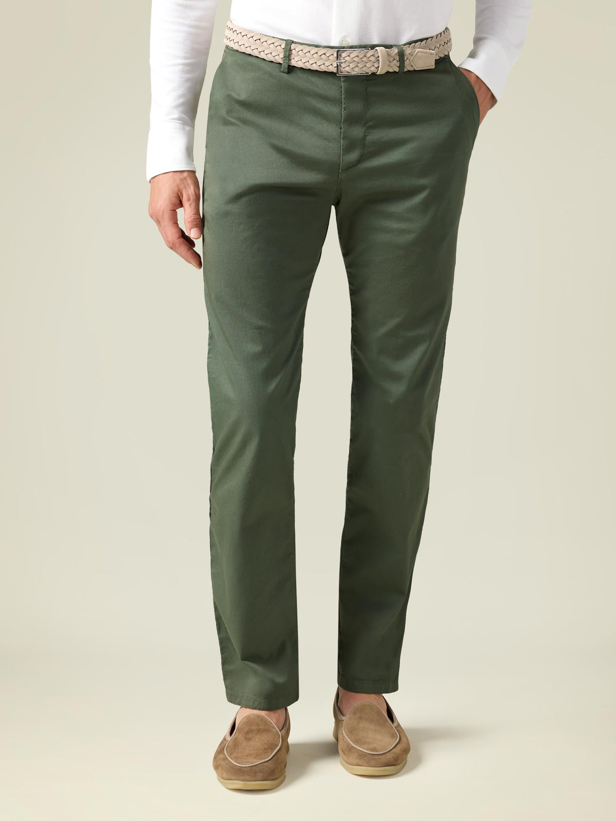 Model from the front wearing the Sand Woven Suede Belt, styled with olive green chinos and a white long-sleeve shirt.