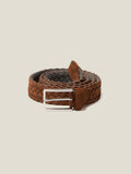 A coiled Luca Faloni woven belt in light brown suede leather, featuring its silver-finished buckle.