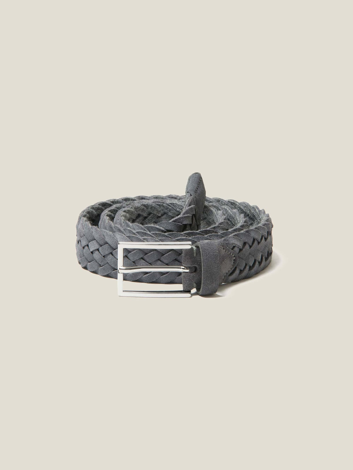 Studio shot of the Luca Faloni grey woven suede belt, coiled to showcase its texture and silver-finished buckle.