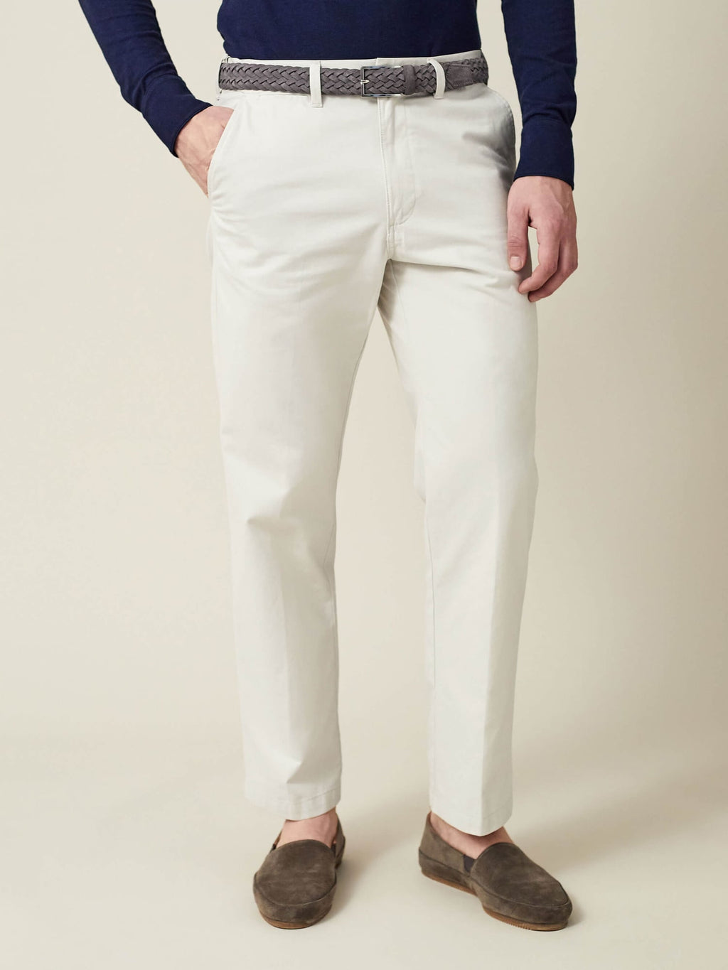 Model wearing the grey woven suede leather belt with off-white chinos, a navy top, and brown suede loafers.