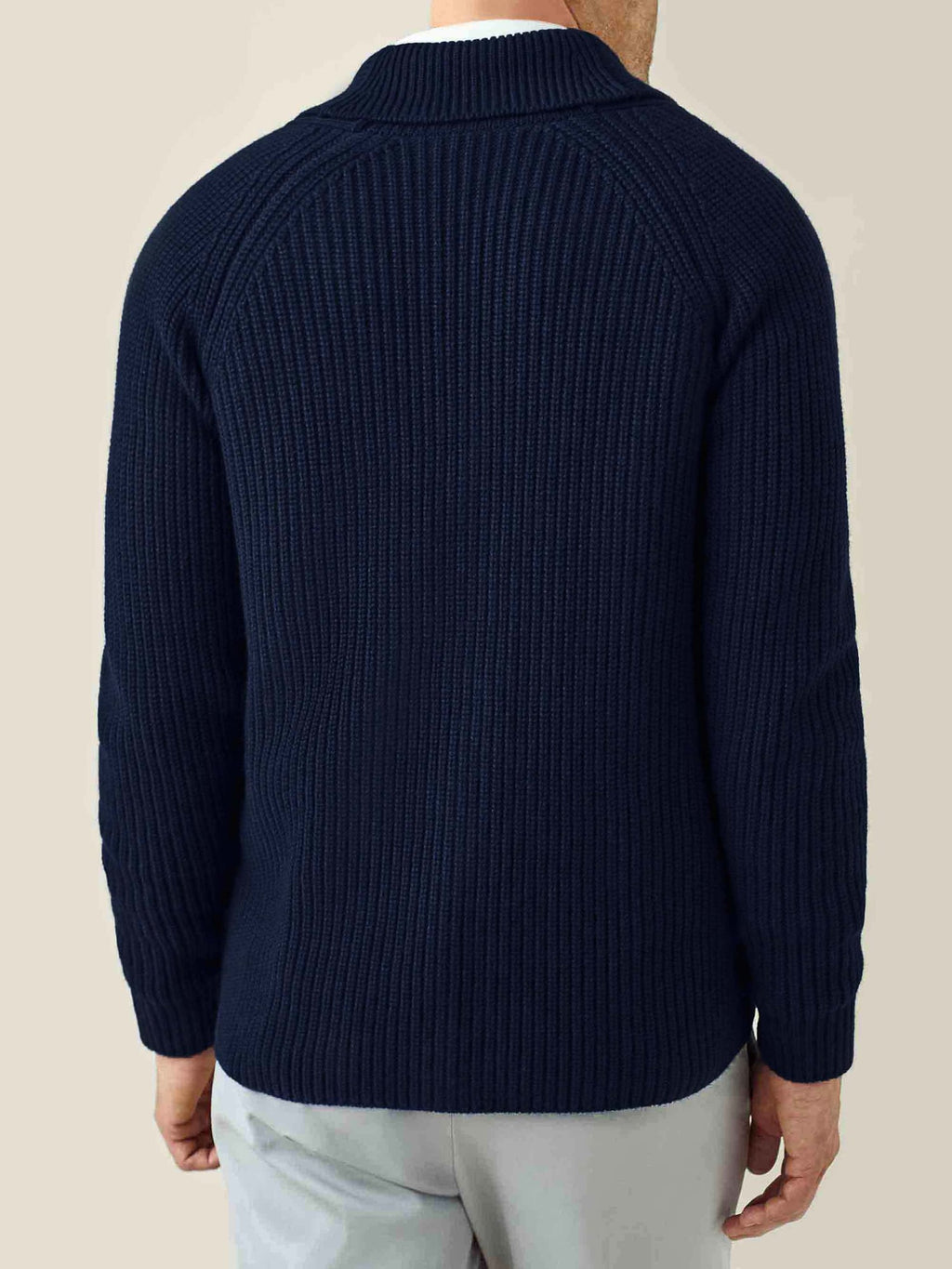 Man from behind wearing Luca Faloni's Chunky Knit Cardigan in Midnight Blue cashmere, showing the ribbed texture and fit.