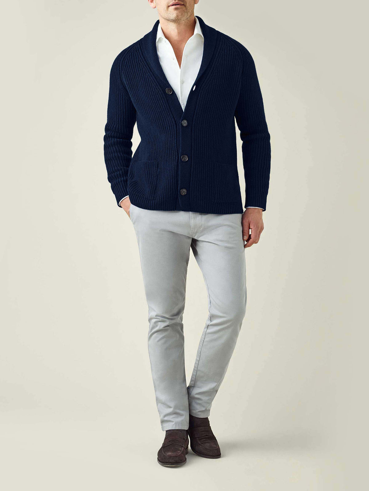 Full view of a model wearing the Luca Faloni Midnight Blue Chunky Knit Cardigan with a white shirt and grey trousers.