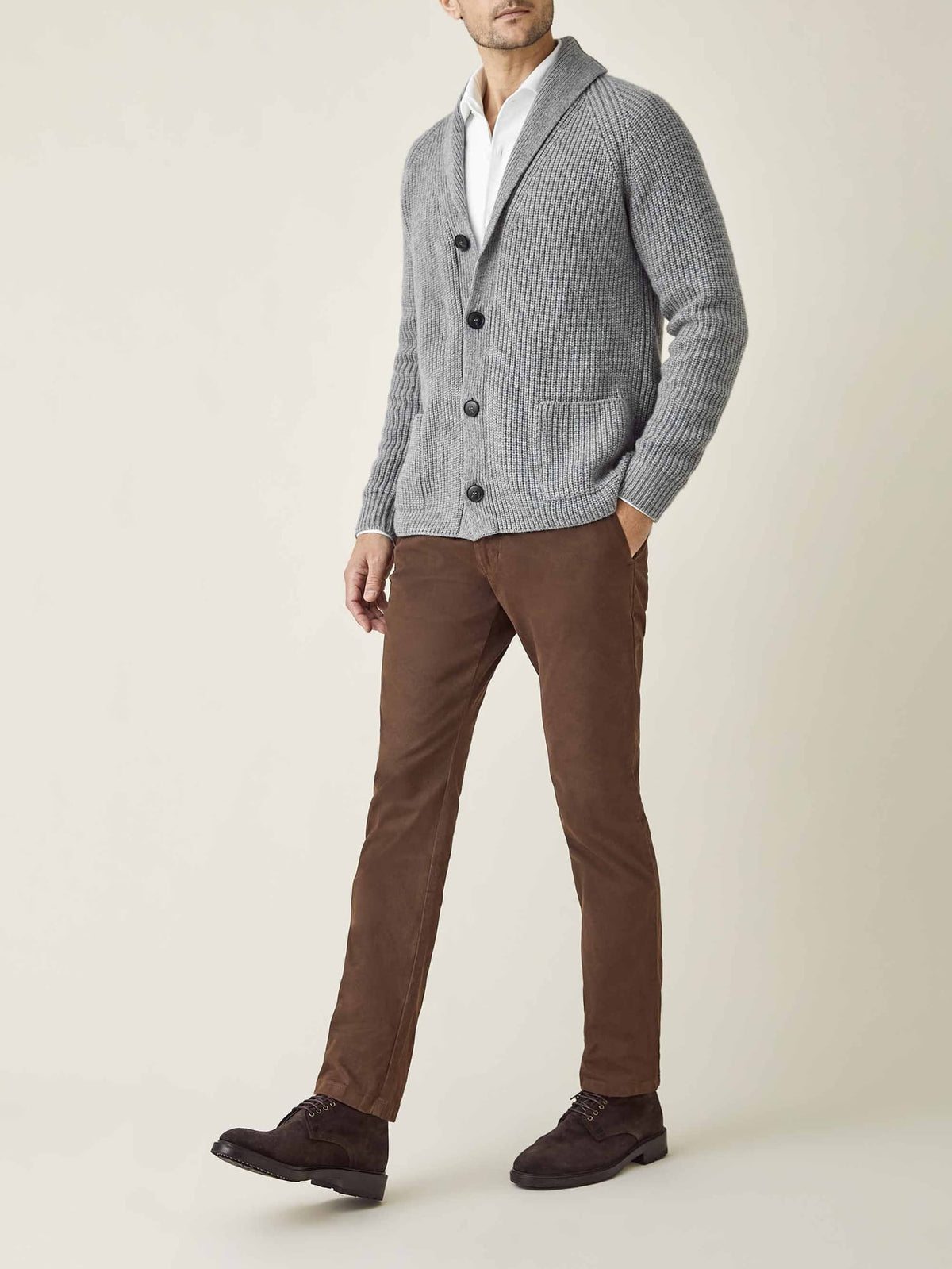 Model wearing the Dolomiti Grey Chunky Knit Cardigan, styled with a white shirt and brown trousers.