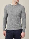 A man models the Dolomiti Grey Cashmere Cable Knit, showcasing its refined texture and classic crew neck design.