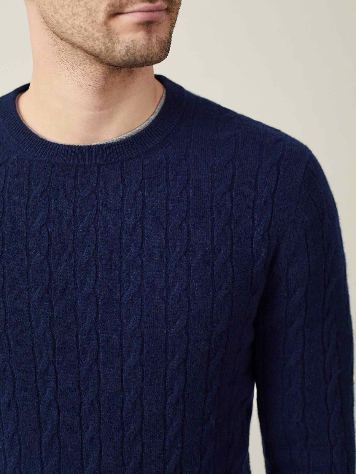 Detailed close-up of a man wearing the Midnight Blue Cashmere Cable Knit, showing the intricate texture and crew neckline.