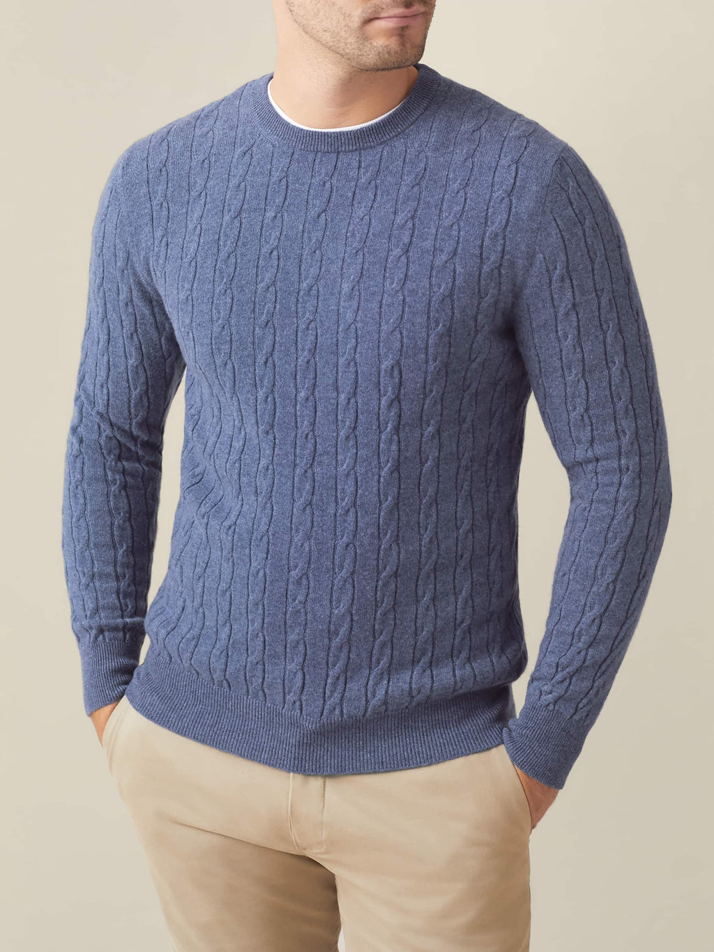 Front view of a model wearing the Sialia Blue Cashmere Cable Knit jumper with light beige chinos.