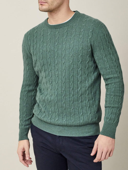 Front view of a model wearing the Luca Faloni pure cashmere Cable Knit in Marine Green.