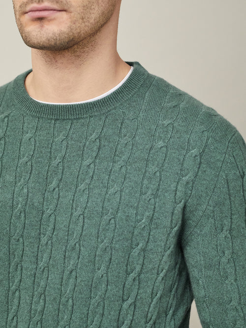 A close-up of a man wearing the Marine Green Cashmere Cable Knit, showing the intricate knit texture and crew neckline.