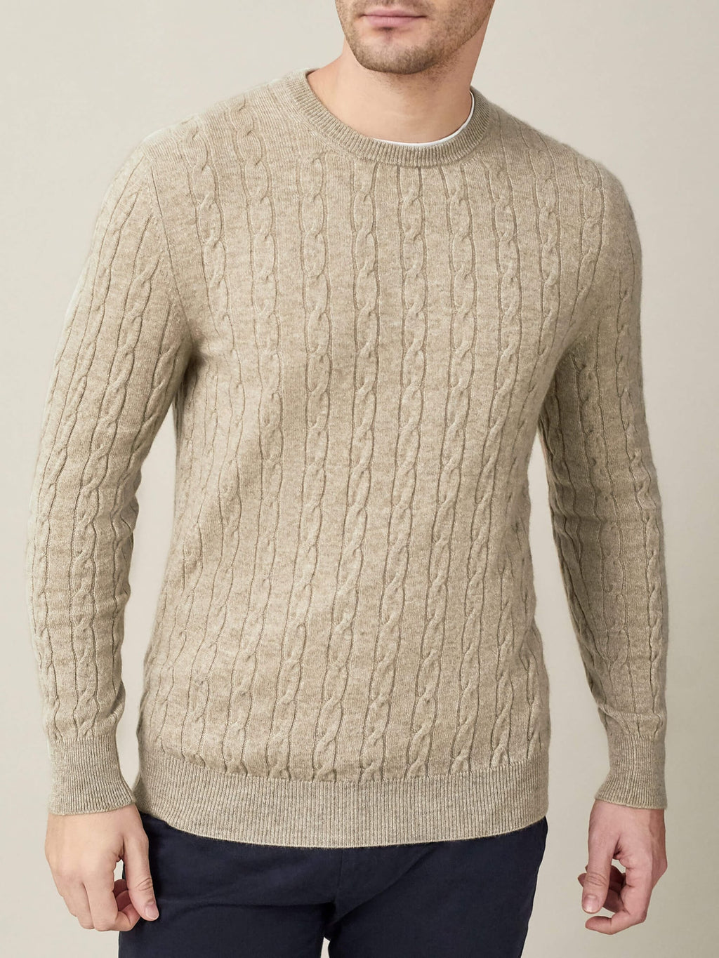 Front view of a man wearing the pure cashmere Cable Knit jumper in Camel Beige by Luca Faloni.