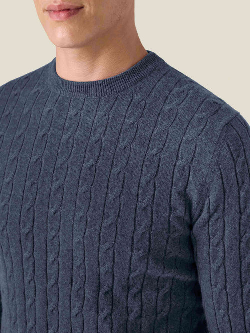Close-up of a man wearing the Atlantic Blue Cashmere Cable Knit, showing the detailed texture and ribbed crew neck.