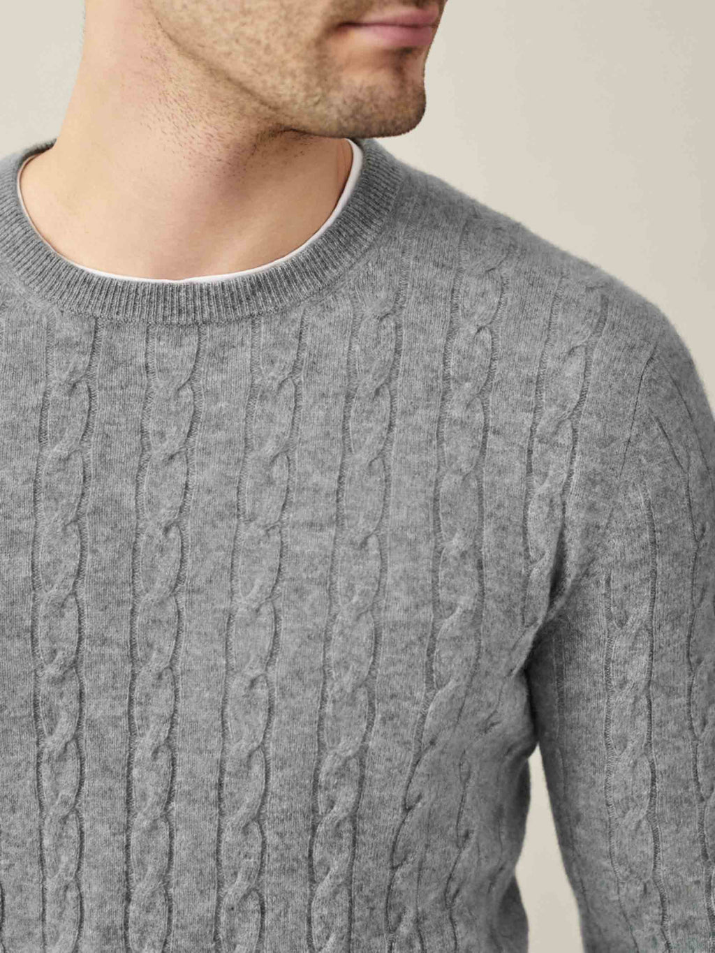 Close-up of the Dolomiti Grey Cashmere Cable Knit, showcasing the intricate texture and classic crew neckline on a model.