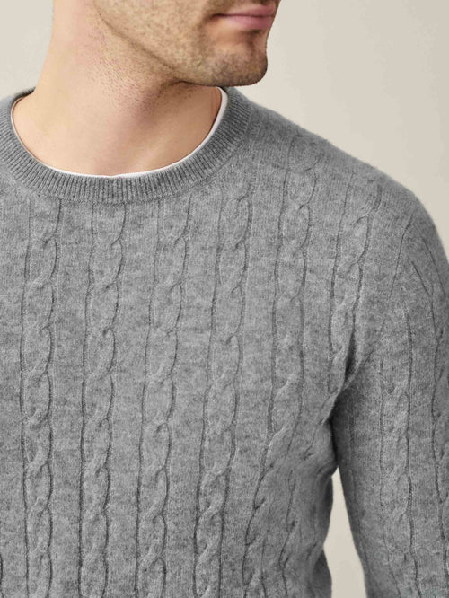 Close-up of the Dolomiti Grey Cashmere Cable Knit, showcasing the intricate texture and classic crew neckline on a model.