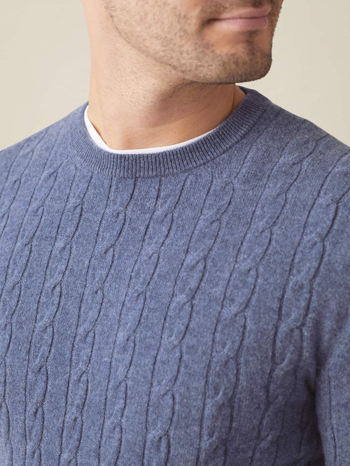 Close-up of a man wearing the Sialia Blue Cashmere Cable Knit jumper, showing the detailed texture and crew neckline.