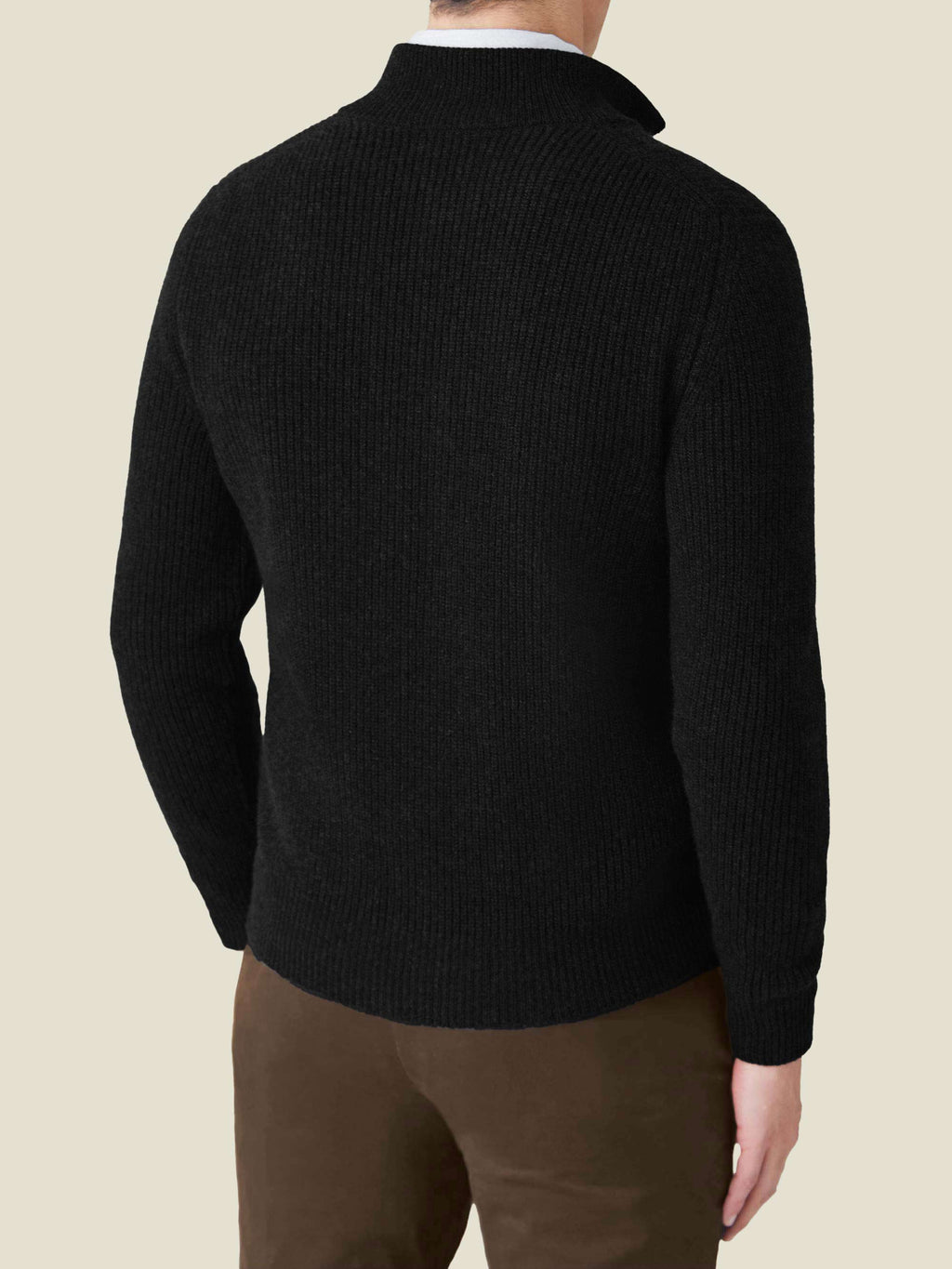 Rear view of a model wearing the Black Chunky Knit Cashmere Zip Cardigan, showcasing its relaxed fit and ribbed texture.