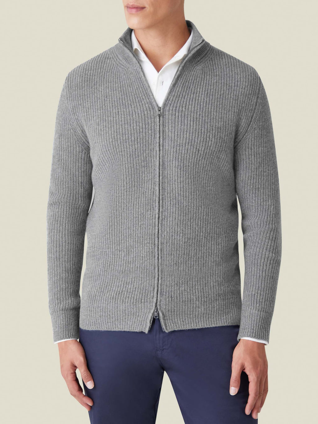 Front view of a model wearing the Chunky Knit Zip Cardigan in Dolomiti Grey, layered over a white collared shirt.