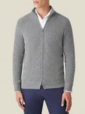 Front view of a model wearing the Chunky Knit Zip Cardigan in Dolomiti Grey, layered over a white collared shirt.