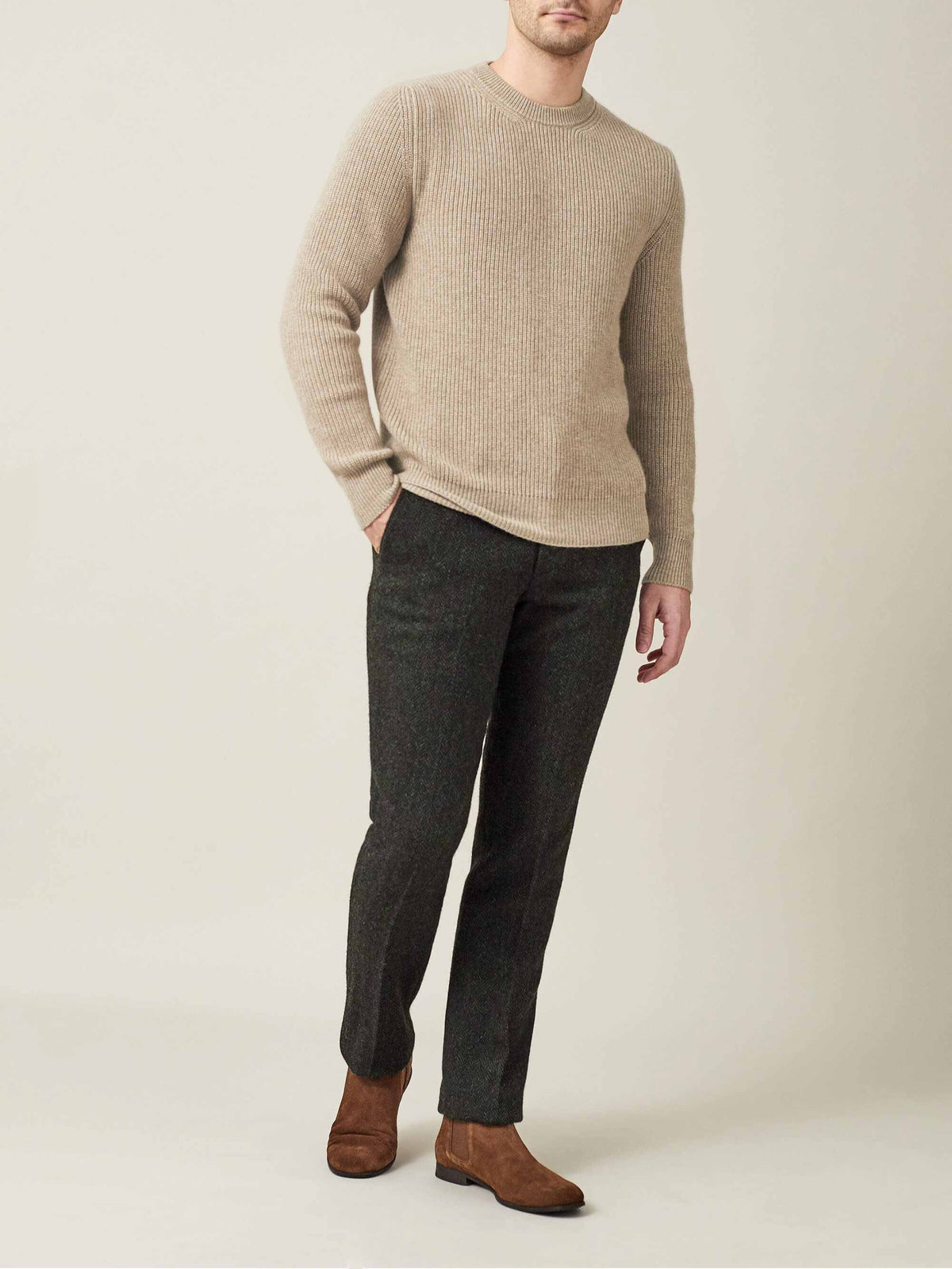 A model wears the Chunky Knit Cashmere Crew Neck in Camel Beige, paired with dark trousers and brown suede boots.