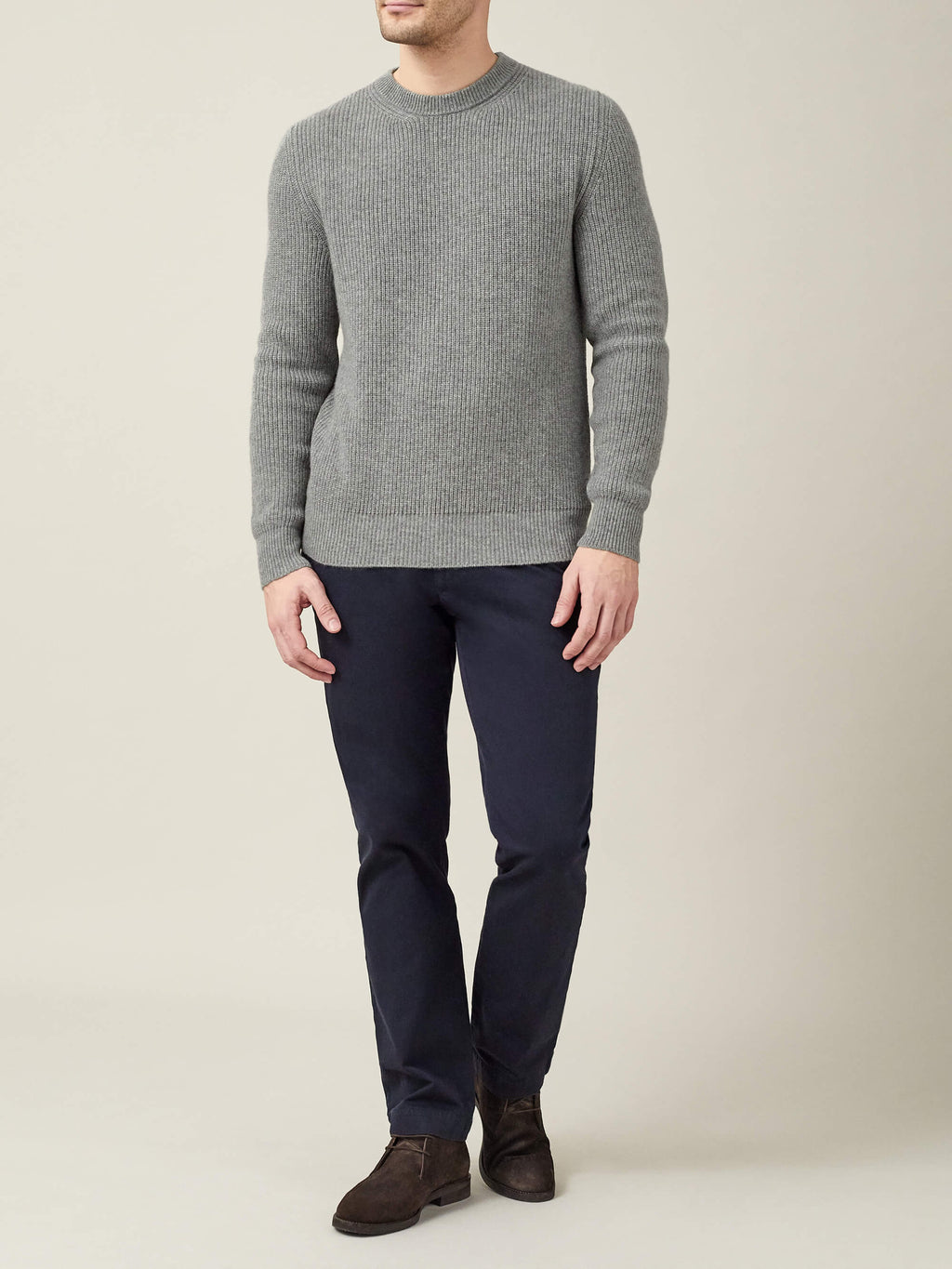 Full length view of a man wearing the Dolomiti Grey Chunky Knit Cashmere Crew Neck with navy trousers and dark brown shoes.