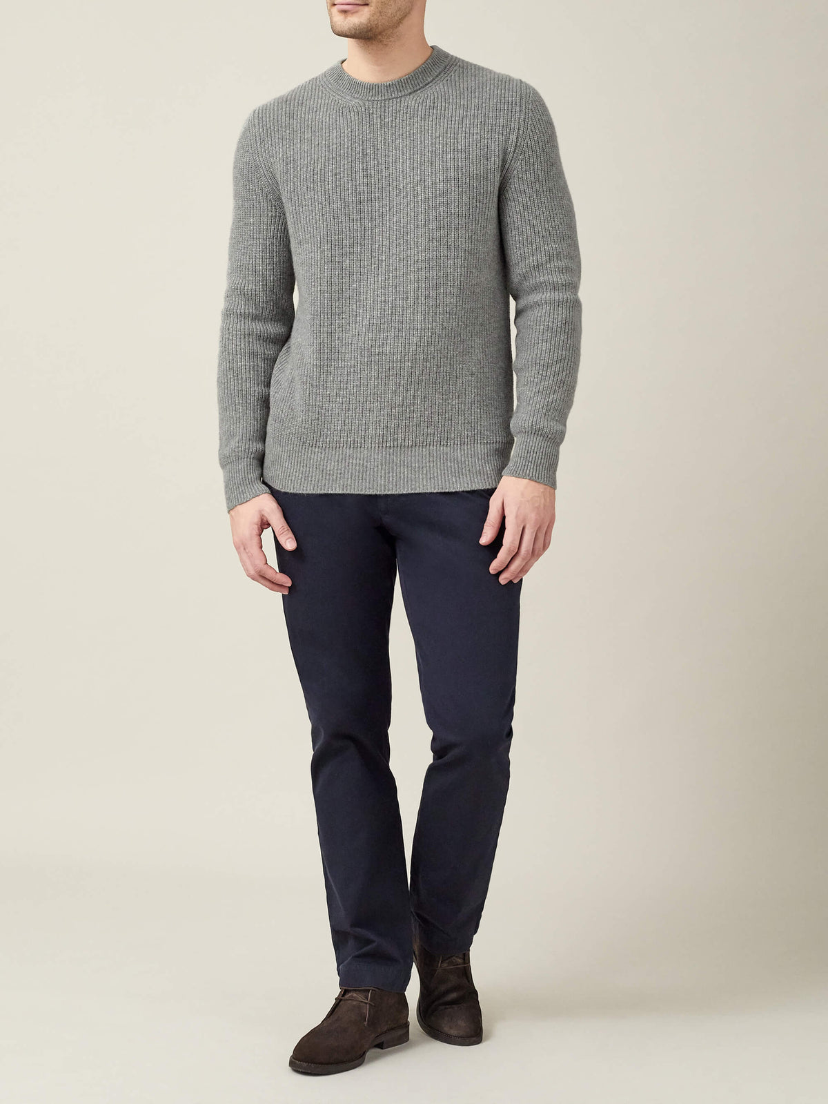 Full length view of a man wearing the Dolomiti Grey Chunky Knit Cashmere Crew Neck with navy trousers and dark brown shoes.