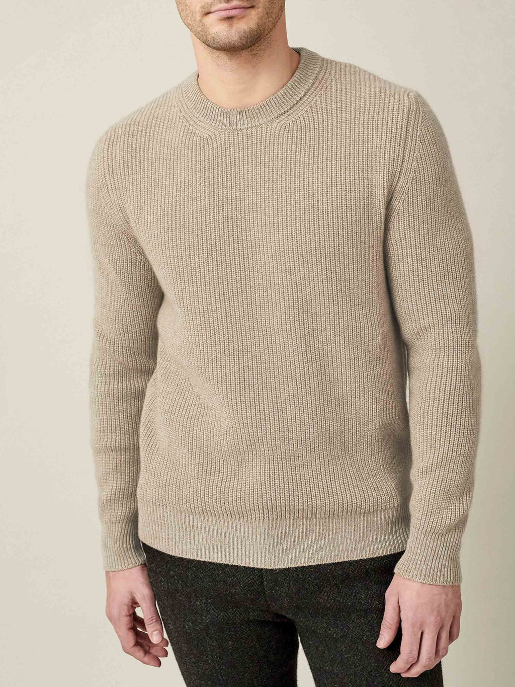 Model wears the Luca Faloni Chunky Knit Crew Neck in Camel Beige, a four-ply cashmere jumper with a ribbed, relaxed fit.