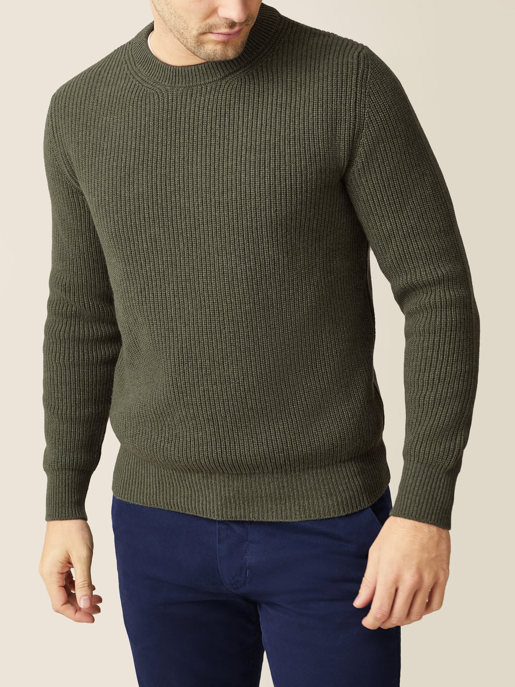A model wears the dark green Chunky Knit Cashmere Crew Neck jumper by Luca Faloni.
