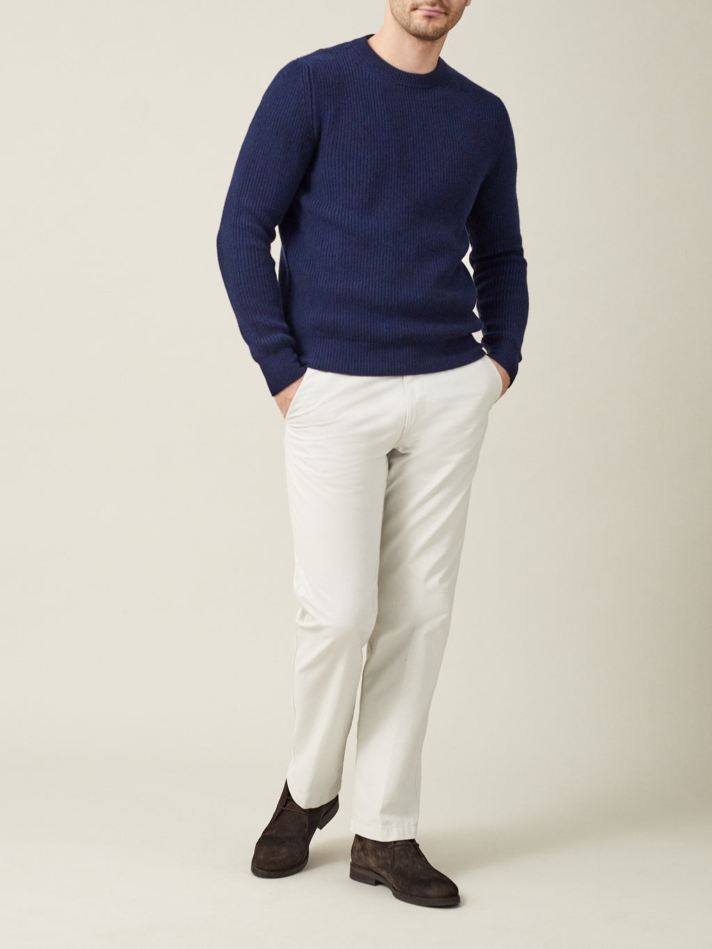 Model wearing the Luca Faloni Chunky Knit Crew Neck in Midnight Blue with off-white trousers and dark brown suede boots.