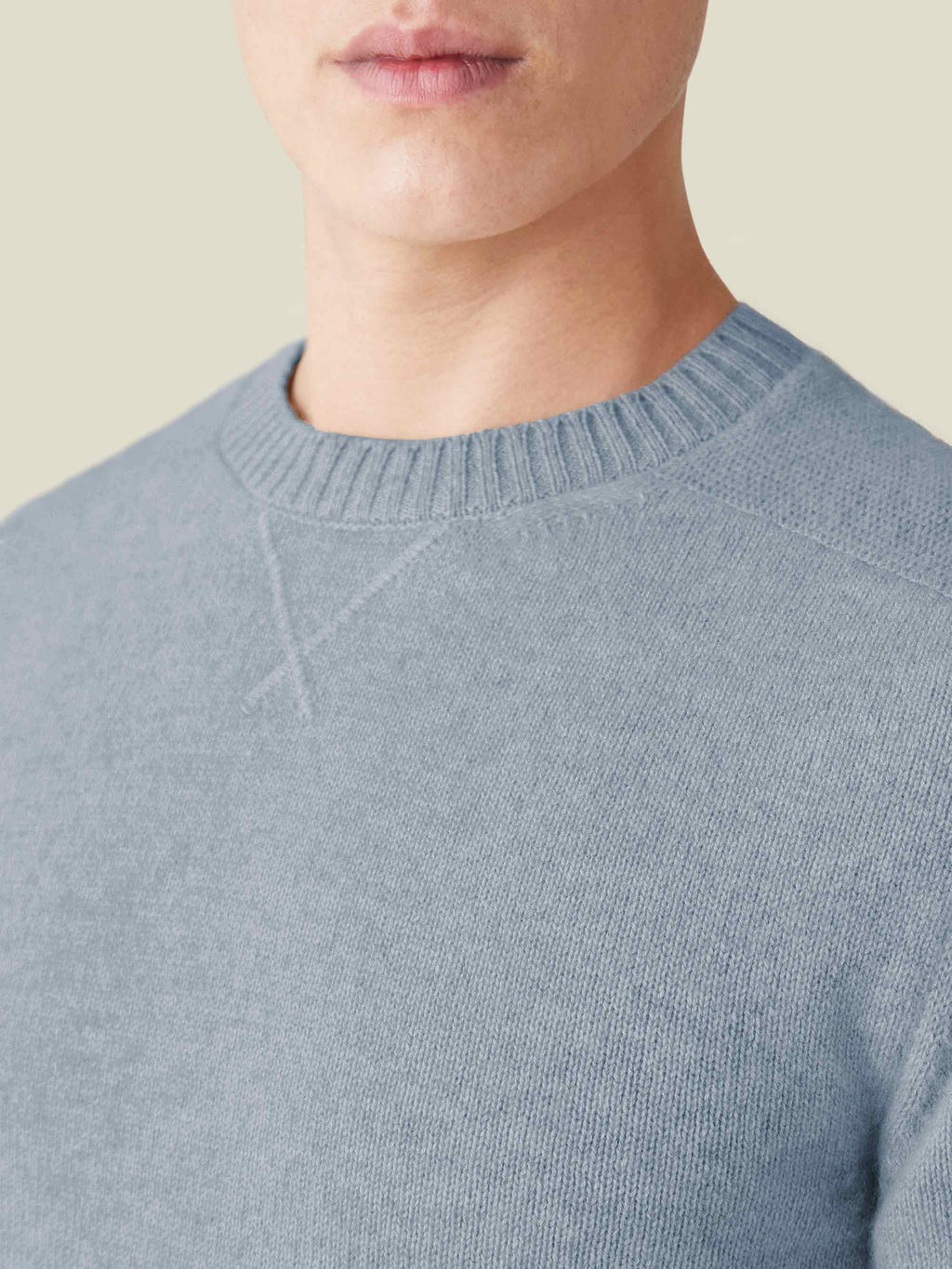 Close-up of the French Blue Cashmere Country Crew Neck, highlighting the ribbed collar and heritage cross-stitch detail.