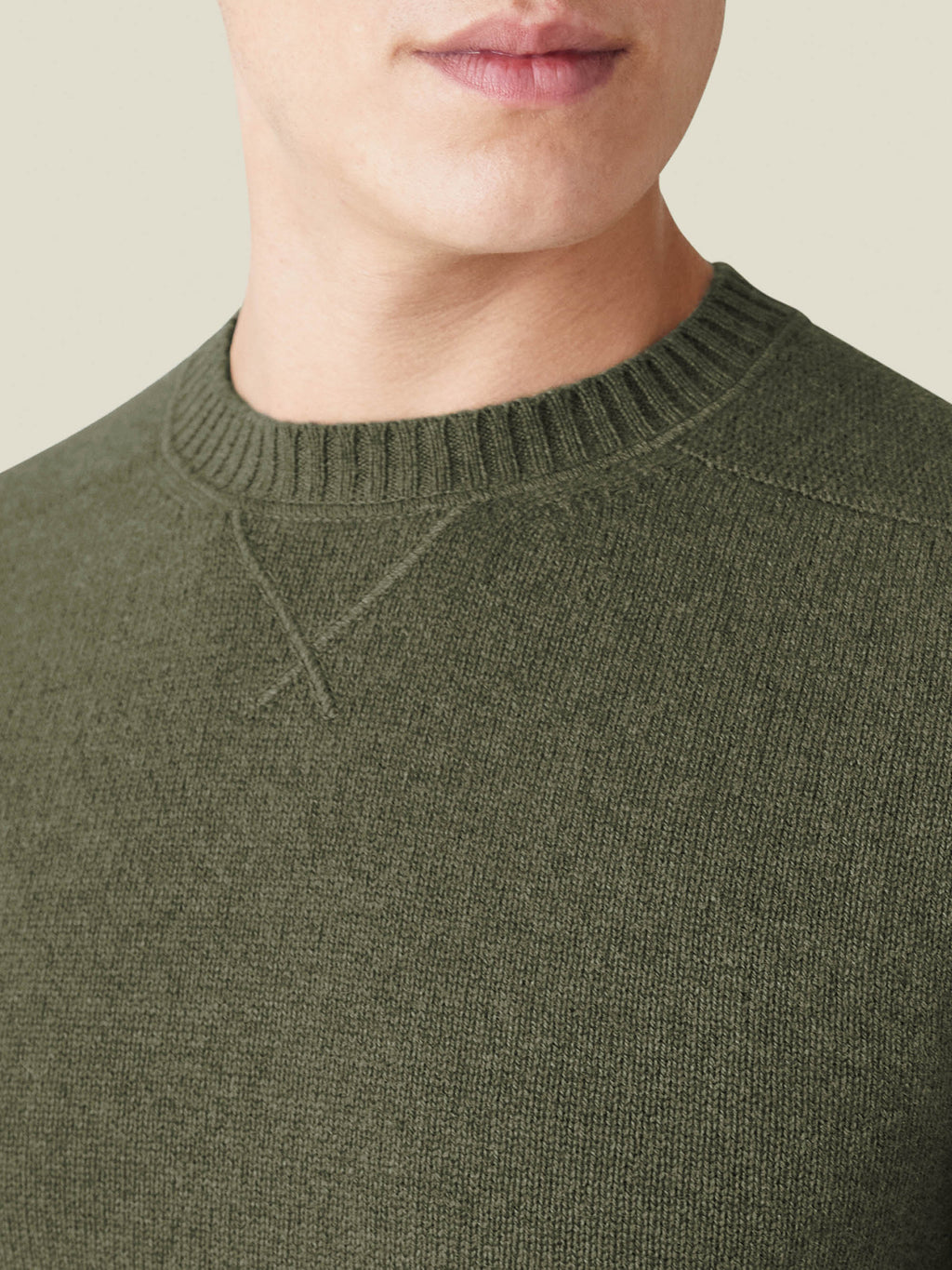 Close-up of the Hunting Green Cashmere Country Crew Neck, showcasing the heritage-inspired cross-stitch collar detail.