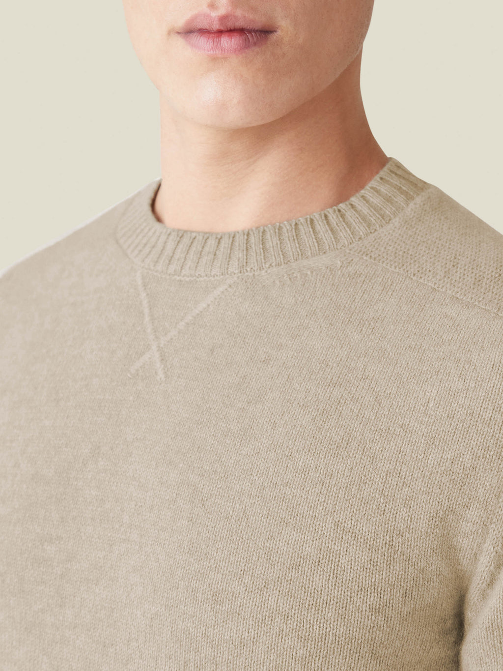 A close-up of the Camel Beige Cashmere Country Crew Neck, focusing on the heritage cross-stitch detail at the collar.