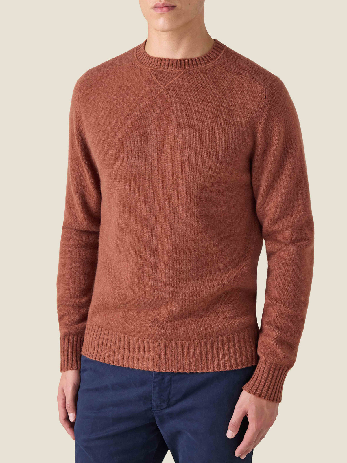 Front view of a model wearing the Luca Faloni Country Crew Neck in rust four-ply cashmere.