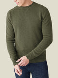 A man wears the four-ply cashmere Country Crew Neck in Hunting Green, showing its relaxed fit and cross-stitch collar.