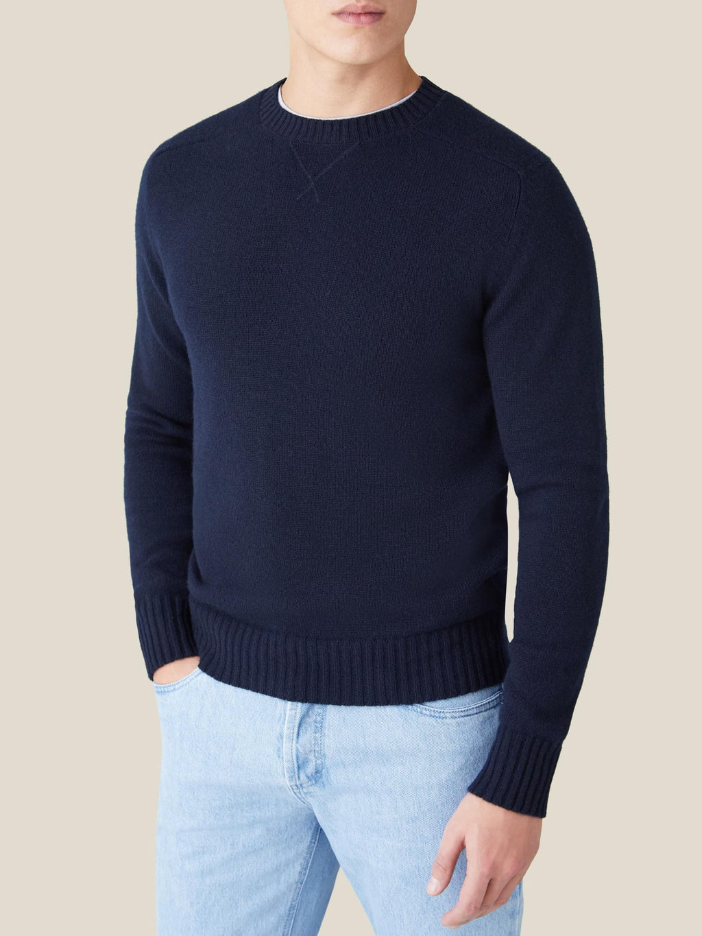 Front view of a man wearing the Country Crew Neck in Midnight Blue cashmere paired with light wash jeans.