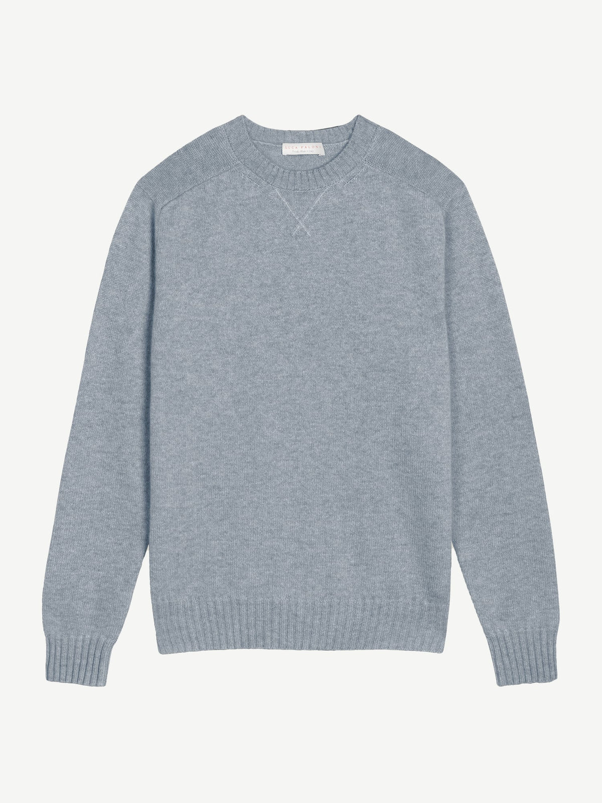 Light blue cashmere Country Crew Neck sweater laid flat, highlighting the heritage cross-stitch collar and ribbed trims.