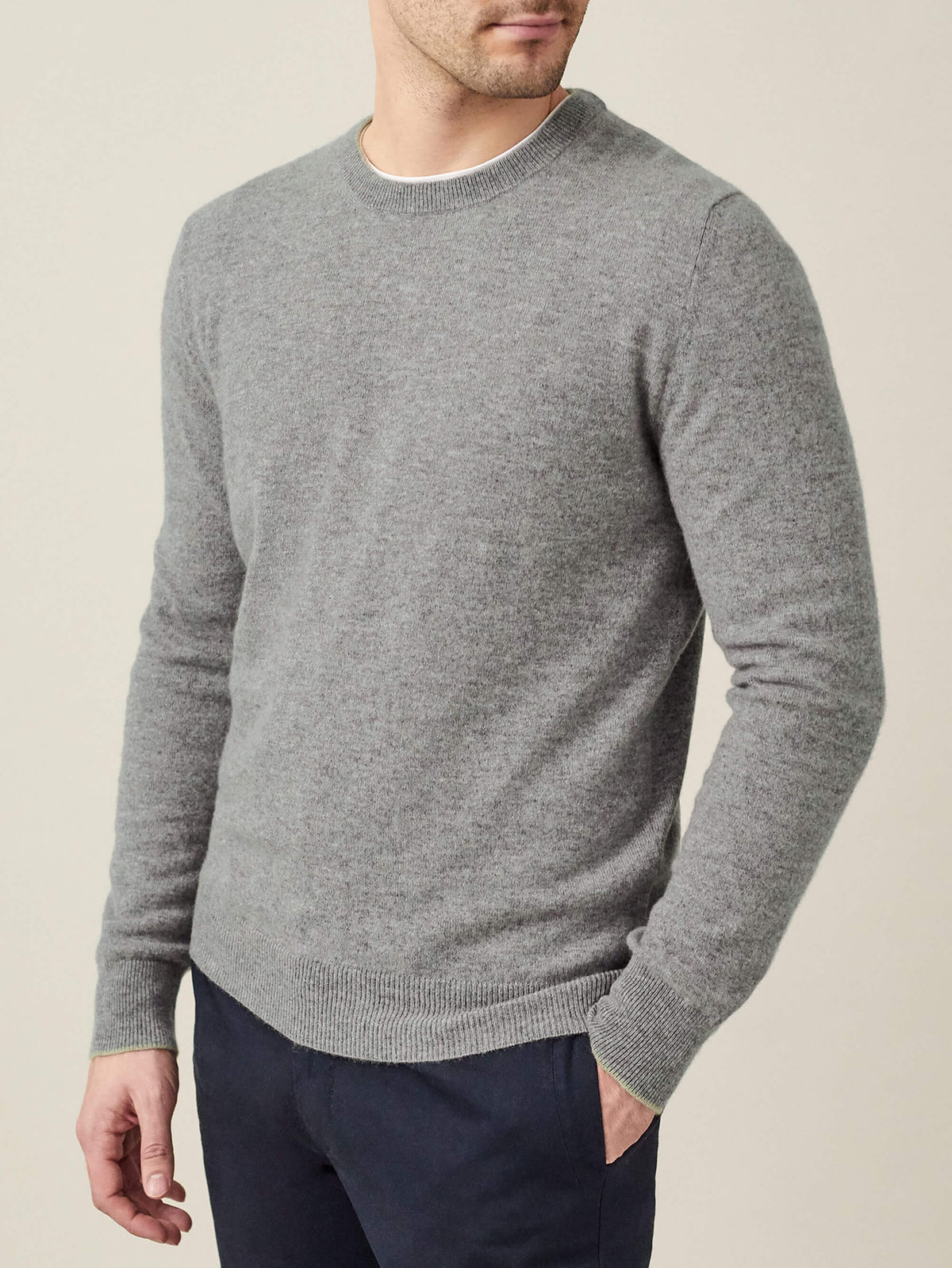 Model wears the Luca Faloni Pure Cashmere Crew Neck in Dolomiti Grey, paired with dark trousers.