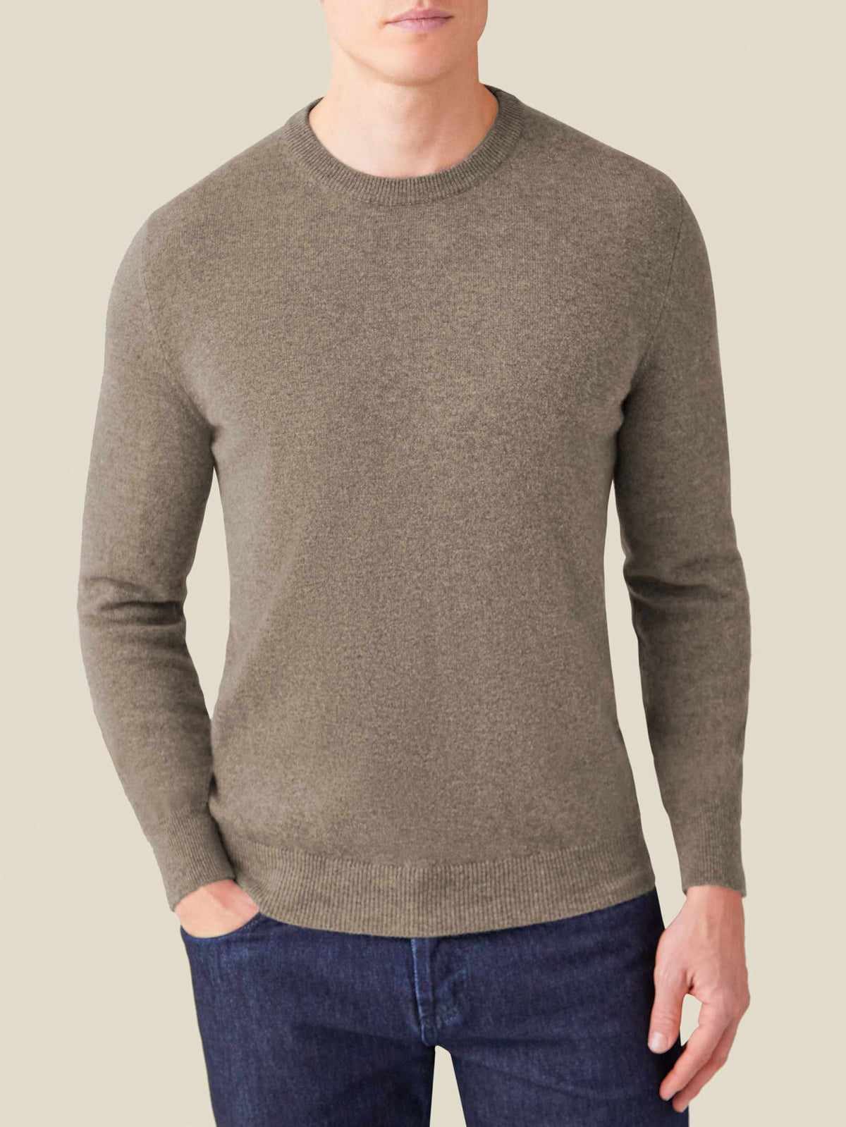 Model wears the Luca Faloni two-ply Cashmere Crew Neck in Nocciola Brown melange, paired with dark denim jeans.