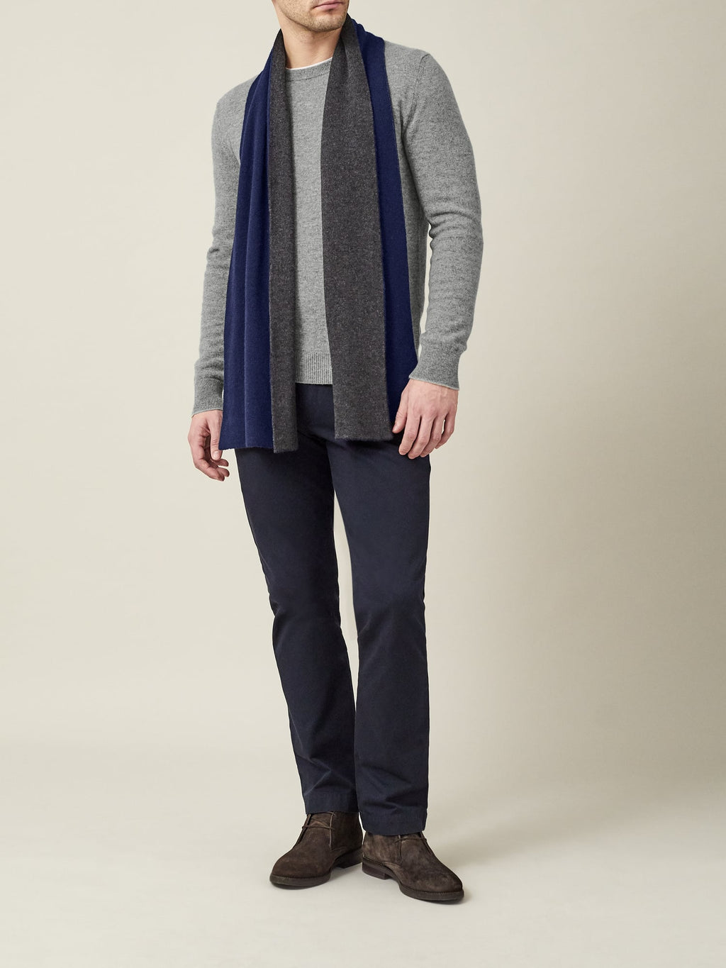 Full-length shot of a model wearing the Dolomiti Grey Pure Cashmere Crew Neck, styled with a scarf and dark trousers.