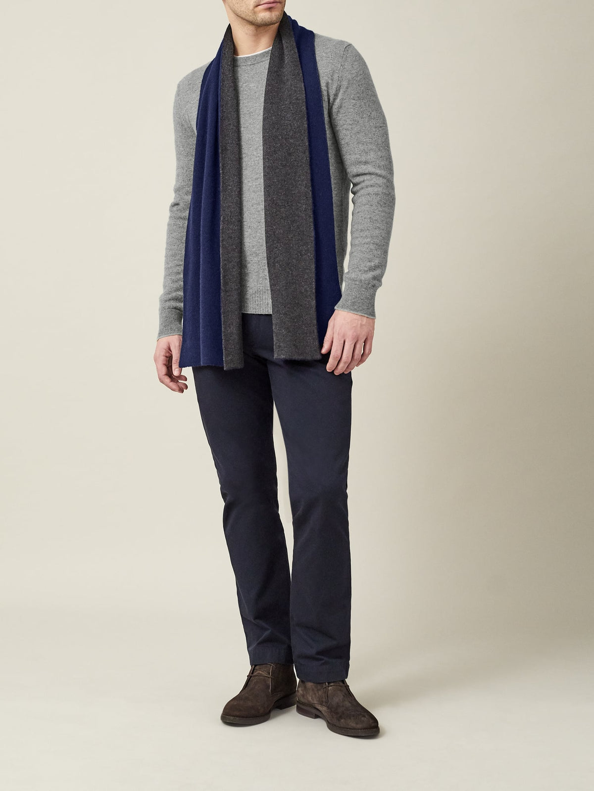 Full-length shot of a model wearing the Dolomiti Grey Pure Cashmere Crew Neck, styled with a scarf and dark trousers.