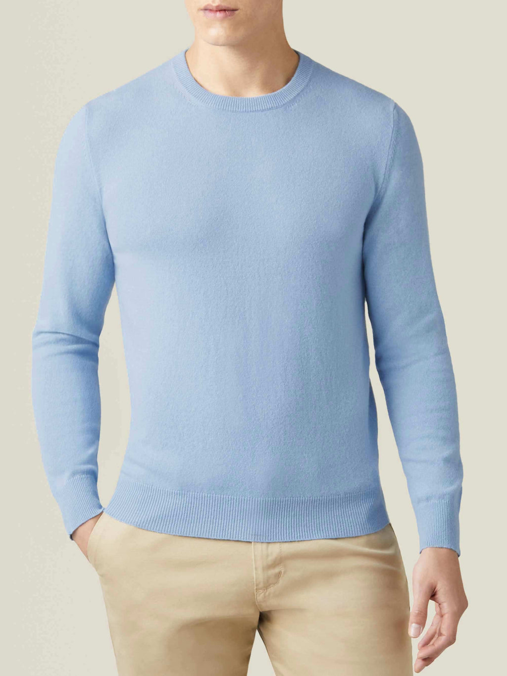 Model wearing the Luca Faloni Sky Blue Cashmere Crew Neck with beige chinos.