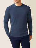 Man wearing the Luca Faloni Cashmere Crew Neck in Atlantic Blue with navy trousers against a neutral background.