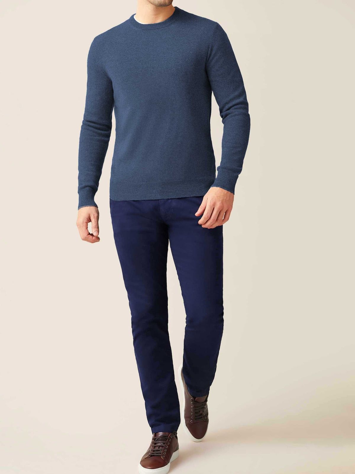 Model wears the Luca Faloni Atlantic Blue Cashmere Crew Neck with navy trousers and brown leather sneakers.