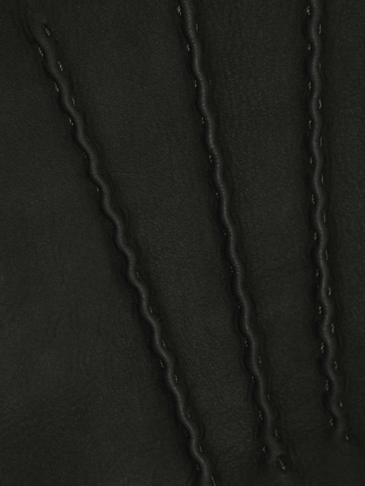 A close-up of the black nubuck leather on the Cashmere-Leather Gloves, showing the three rows of decorative stitching.
