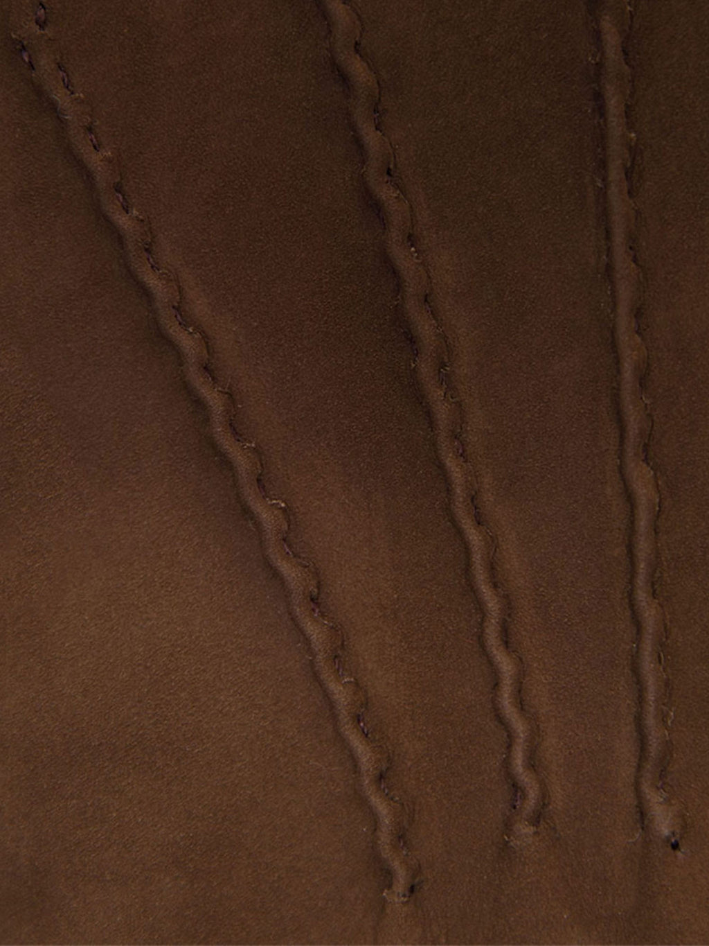 A close-up of the Nocciola Brown Cashmere-Leather Gloves, showcasing the fine nubuck texture and decorative stitching.