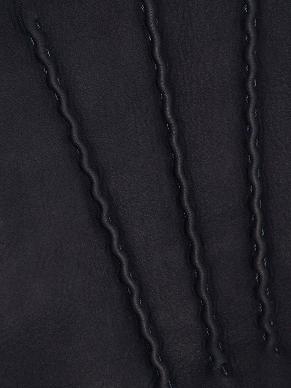 A detailed close-up of the handcrafted stitching on the navy blue nubuck leather of the Cashmere-Leather Gloves.