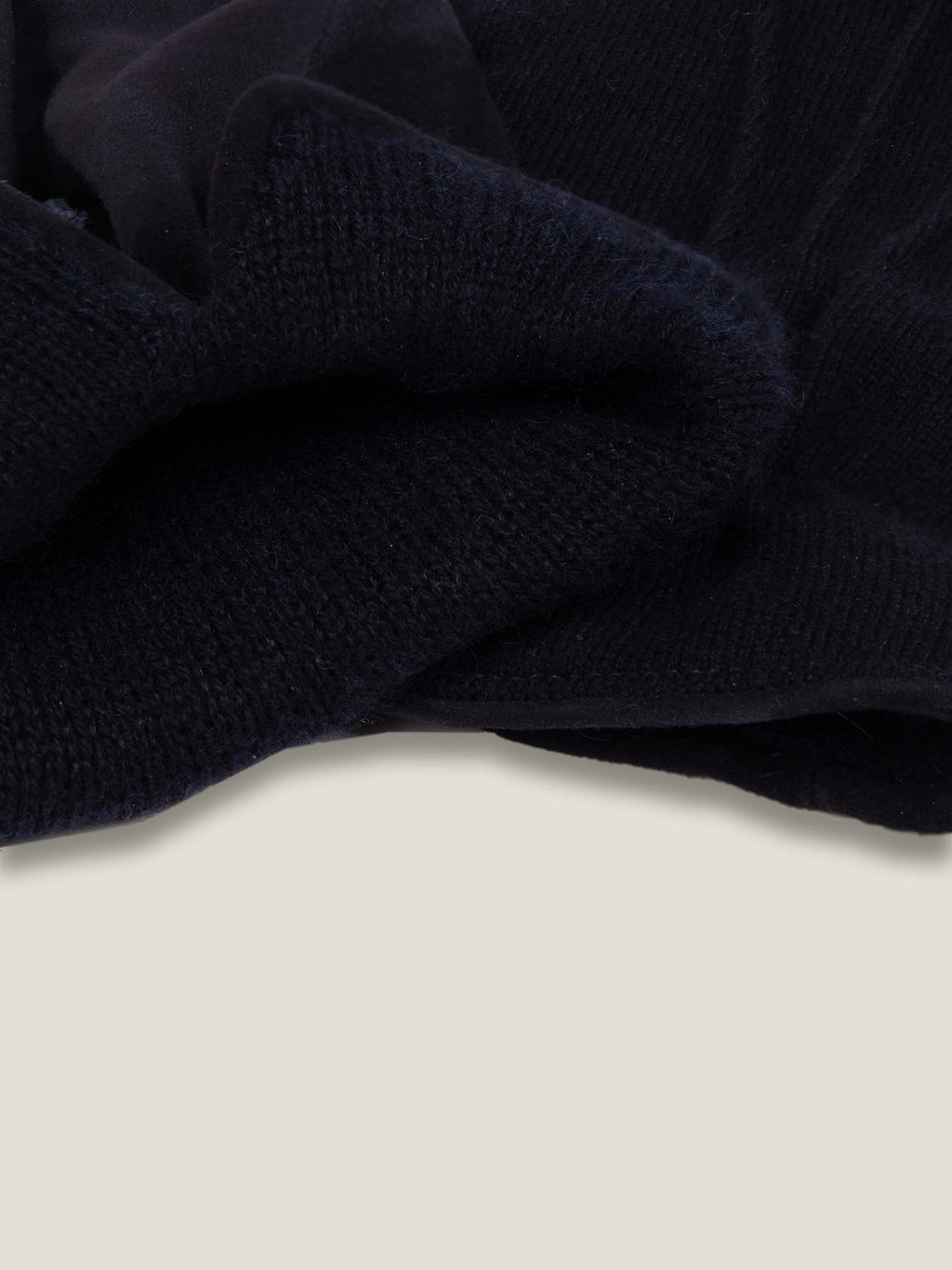 A close-up of the Midnight Blue Cashmere and Suede Gloves, highlighting the soft cashmere lining and ribbed cuff.
