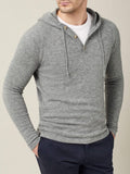Front view of a model wearing the Luca Faloni pure cashmere hoodie in Dolomiti Grey over a white t-shirt and navy trousers.