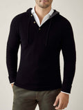 Front view of a model wearing the Luca Faloni black pure cashmere hoodie layered over a white collared shirt.