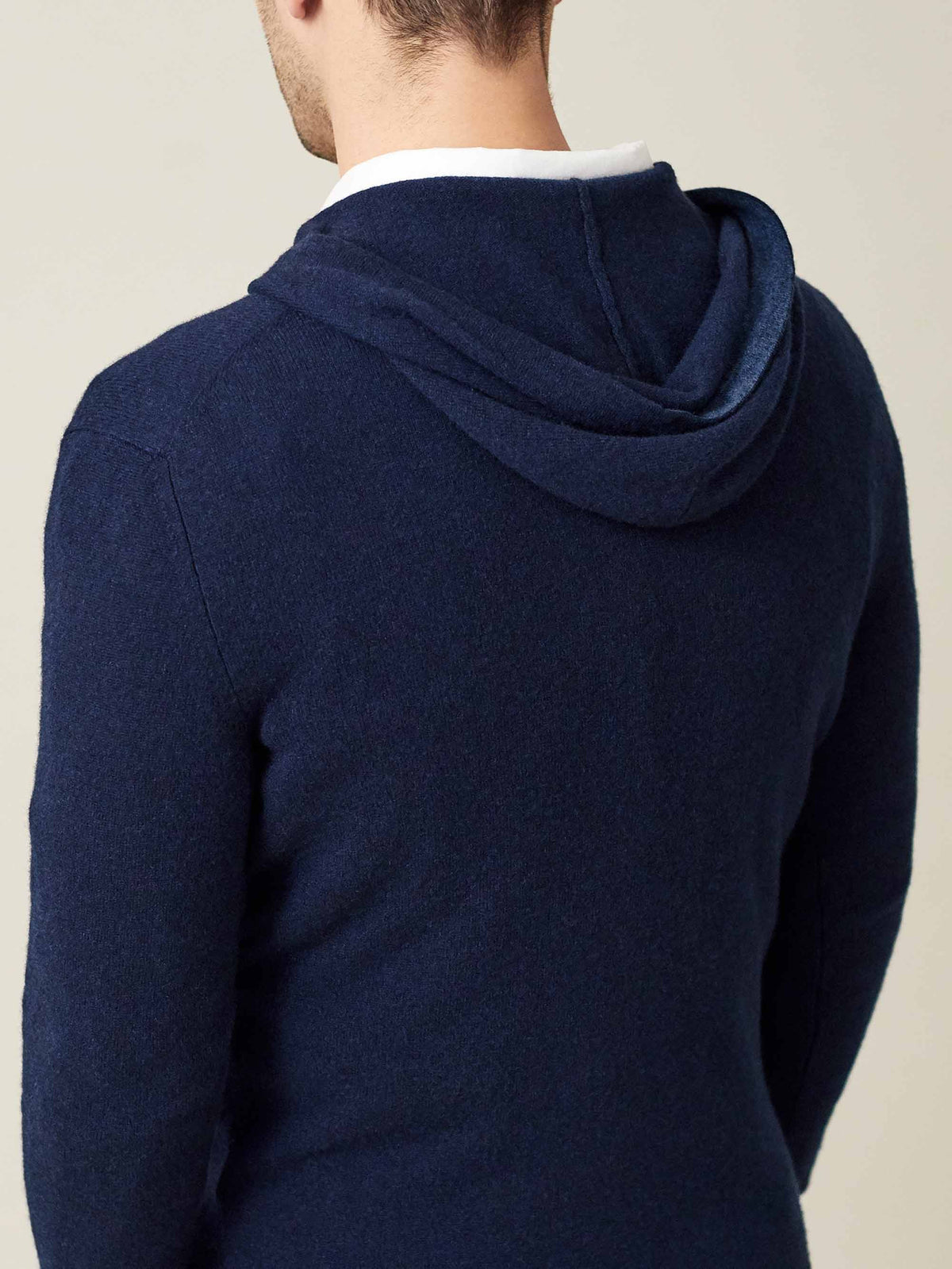 Back view of the Luca Faloni Pure Cashmere Hoodie in navy blue, showcasing the relaxed fit across the shoulders and the hood.