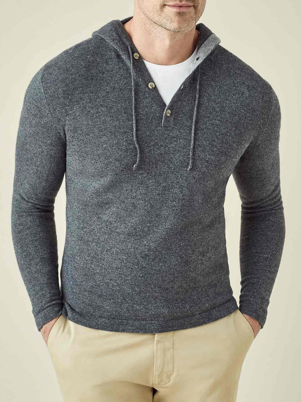 Front view of a man wearing the Stone Grey Cashmere Hoodie, featuring a three-button placket and styled over a t-shirt.